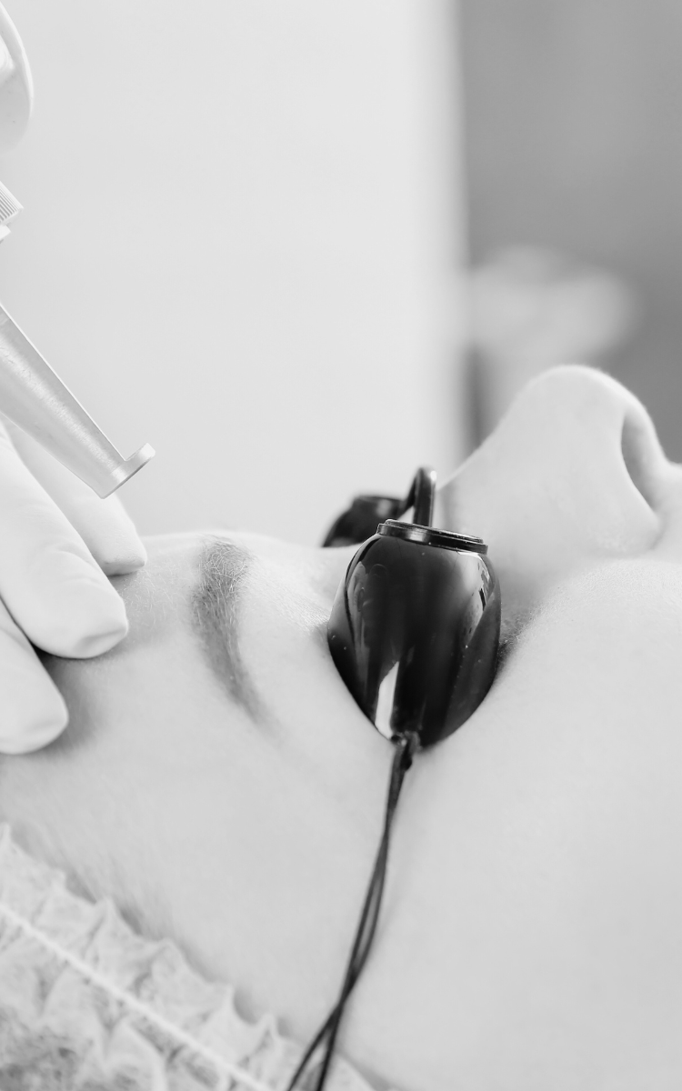 Black and white photo of a woman receiving laser tattoo removal in Kent.