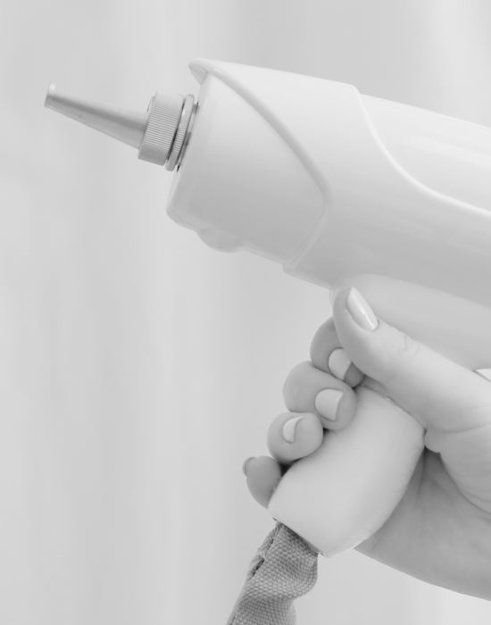 A woman's hand holding an electric hair dryer.