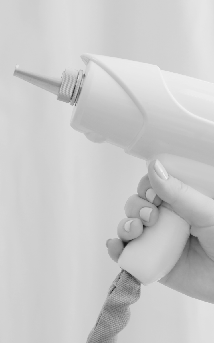 A woman's hand holding an electric hair dryer.