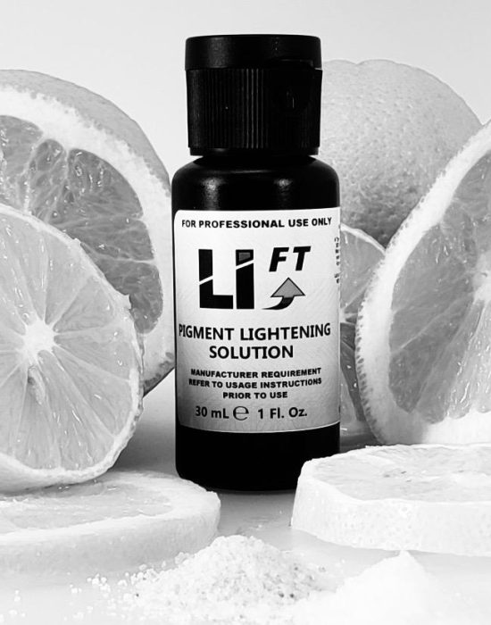 A bottle of liquid lightening solution next to lemon slices.